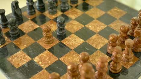 a chess player capturing his opponents pawn with his own in the early stages of the match with a stone chess set