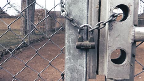 30FPS-Slow-Motion-View-Chain-Link-Fence-Gate-With-Padlock-Chain---Truck-Shot