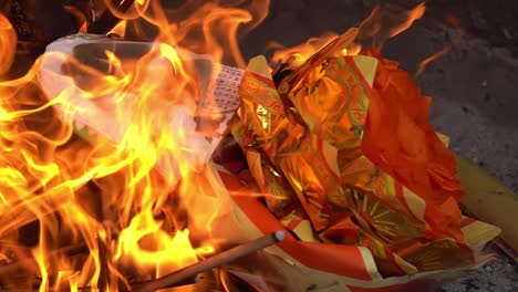Slow-motion-burning-joss-paper-at-furnace-at-chinese-temple