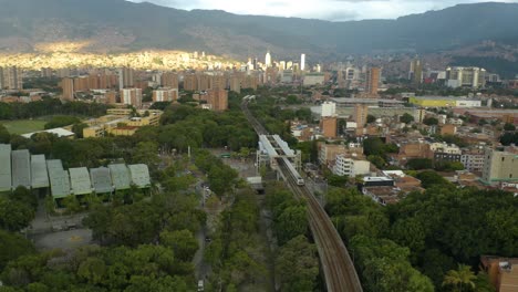 subway metro train enters station in medellin, colombia neighborhood