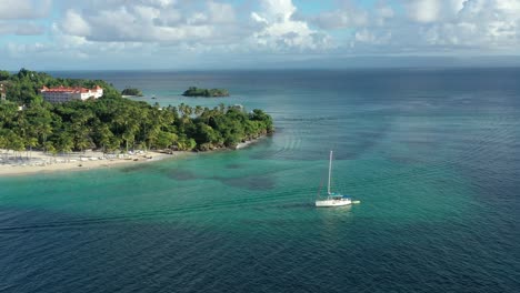 tourists on board of luxurious sailboat anchored in transparent sea water of cayo levantado