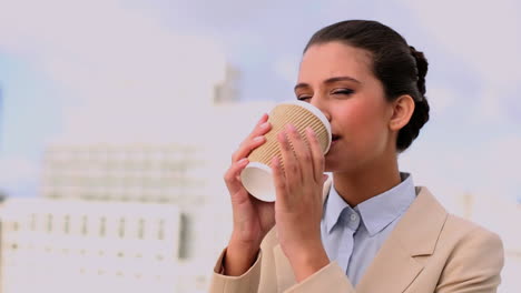 Delighted-beautiful-businesswoman-enjoying-coffee