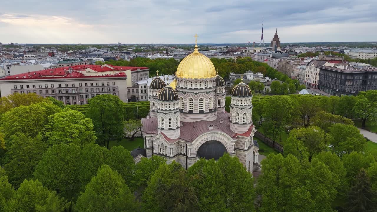 Wide aerial view of Nativity Cathedral surrounded by green tree canopy