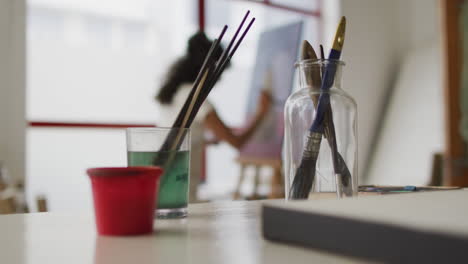 art supplies in focus in a bright classroom, with copy space