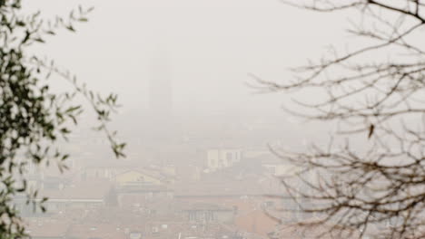 the city of verona, italy on a very foggy day, focus pull