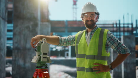 smiling surveyor with total station on construction site