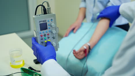 doctor treating patient in clinic. male doctor checking health of young woman