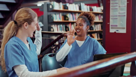 two nursing students studying in the library