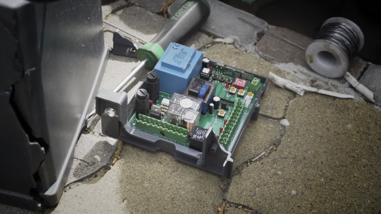 An electric automatic gate control board during repairs. An electric automatic gate control board during repairs.