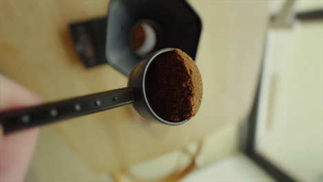 coffee powder is poured into a coffee press view from a unique angle