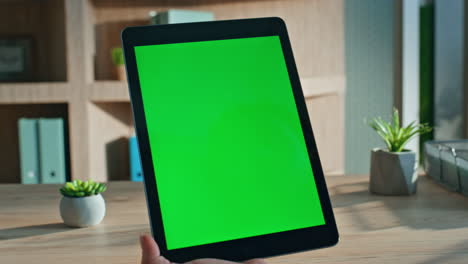 woman swiping chromakey tablet working remotely at apartment office close up.