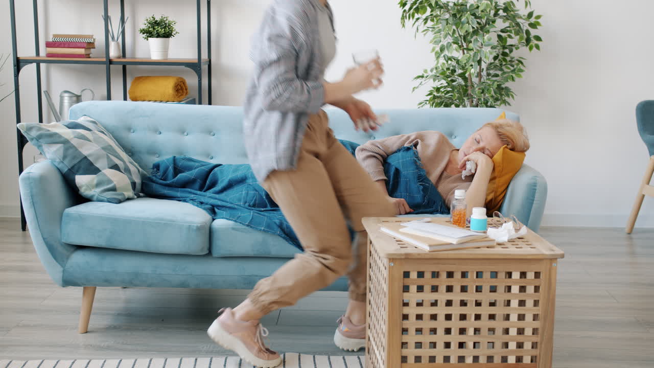 Daughter Caring for Ill Mother on Couch