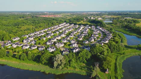 aerial view of residential houses neighborhood and apartment building complex at sunset