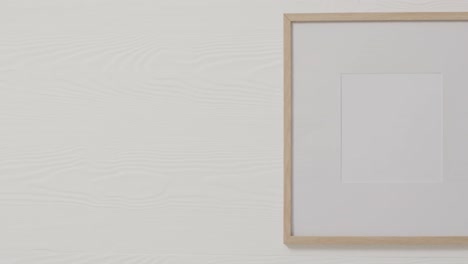 Wooden-frame-with-copy-space-with-white-background-and-white-wall