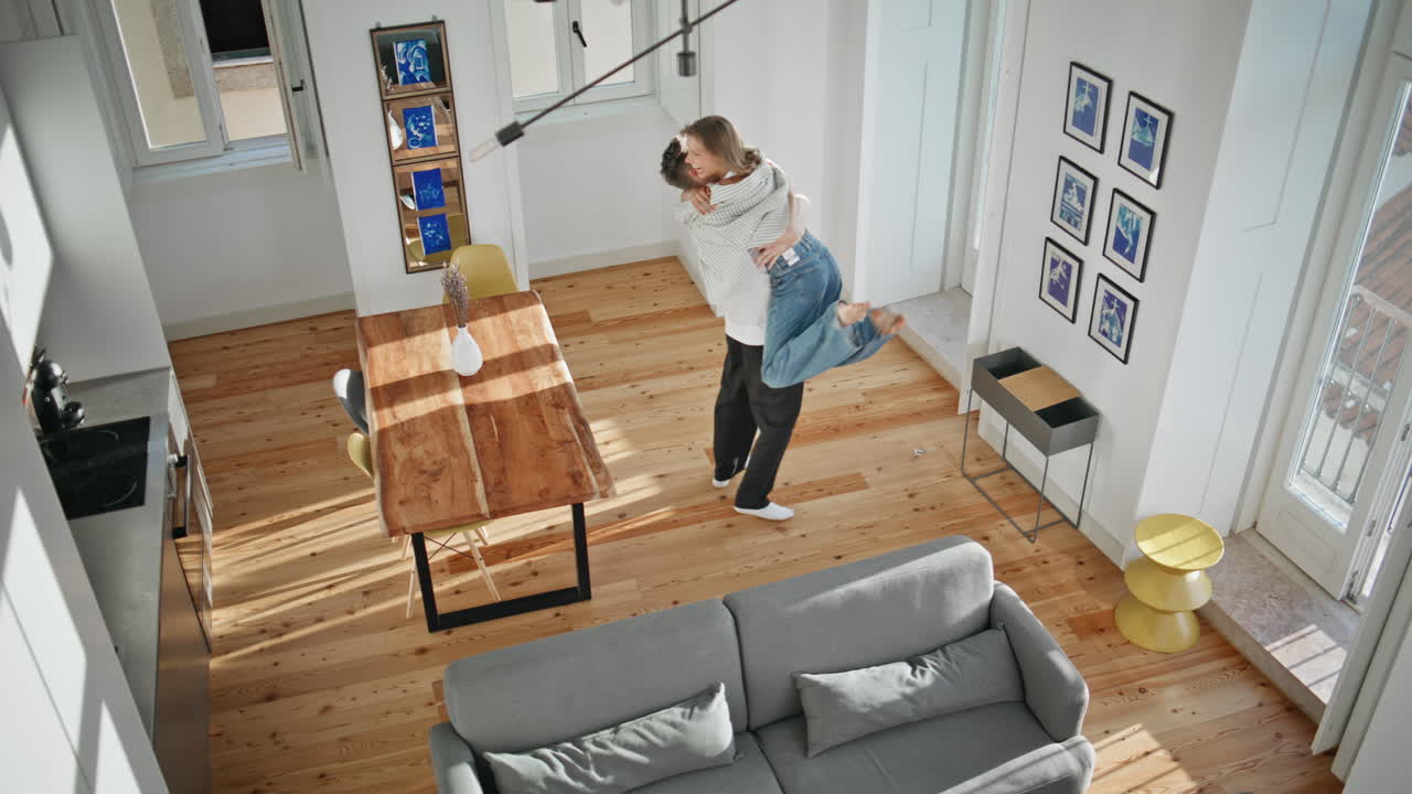 Happy spouses buying house together. Top view excited man giving apartment key