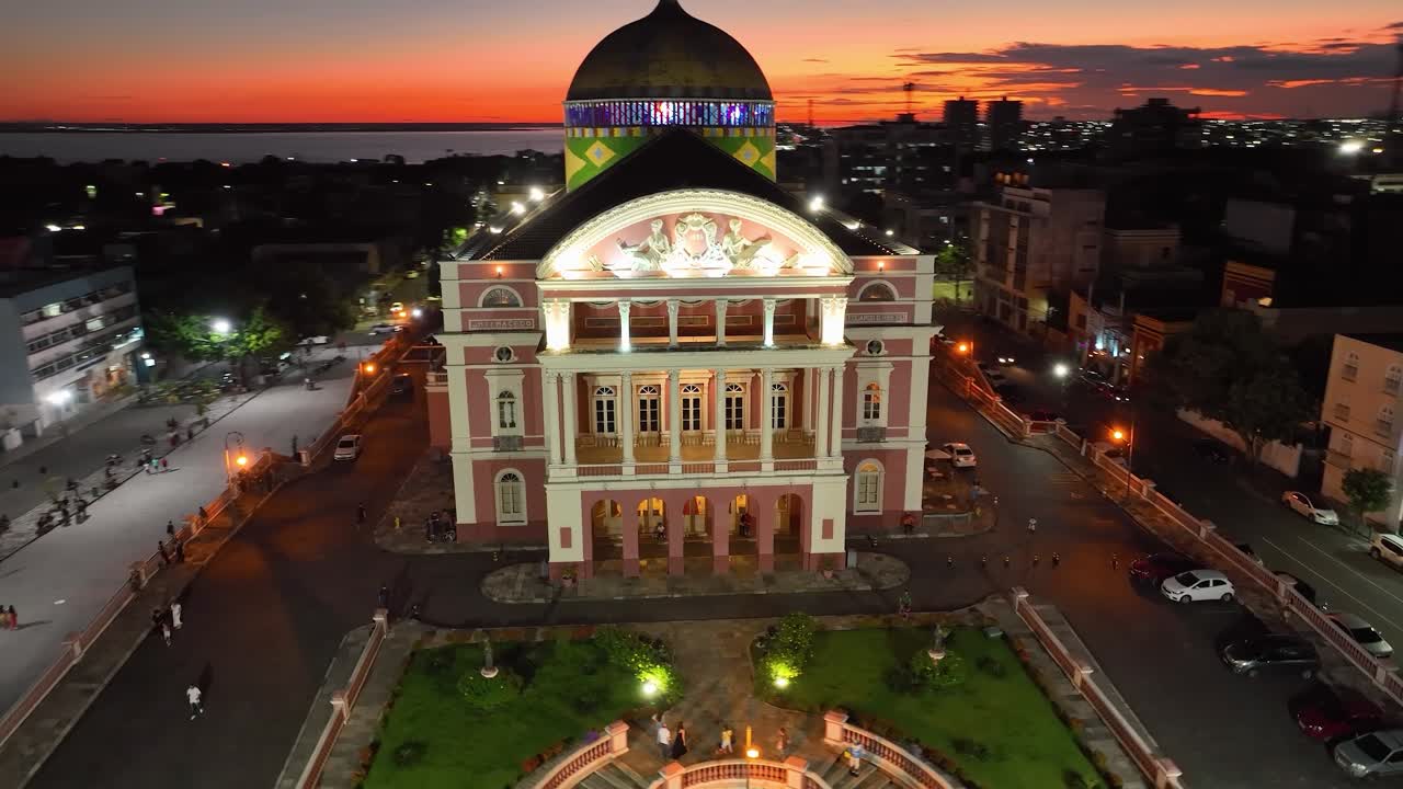 Colorful sunset sky over medieval building at cityscape downtown Manaus Brazil near Amazon river and Amazon Forest. Travel destinations. Sunset skyline. Sunset coastal city at Manaus Brazil.