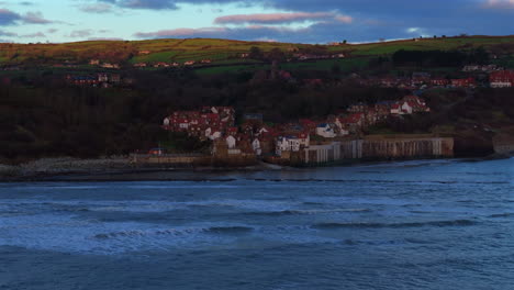 wide angle drone shot of robin hood's bay on overcast morning yorkshire