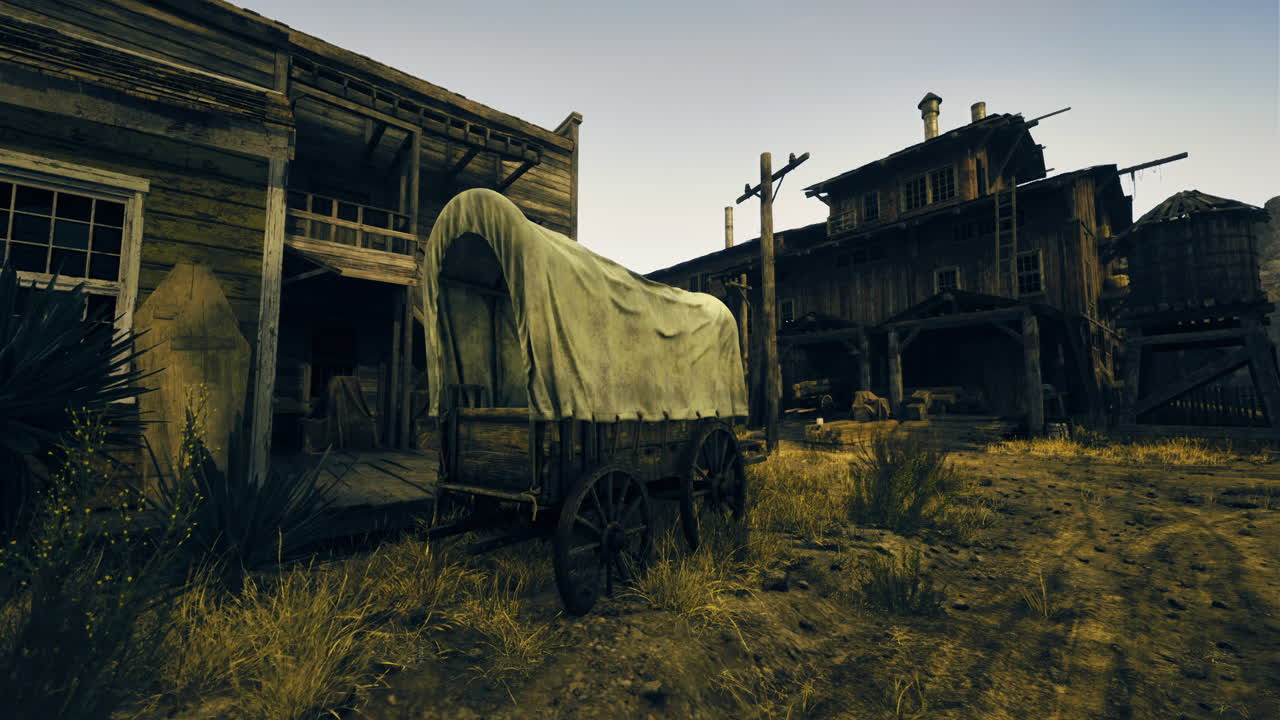 Old wooden wagon parked beside abandoned buildings in a dusty town