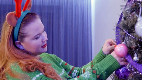 beautiful red hair girl decorate christmas tree