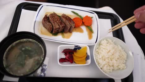 eating steak, vegetables, rice, and miso soup