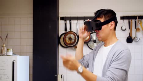 Man-using-virtual-reality-headset-in-kitchen