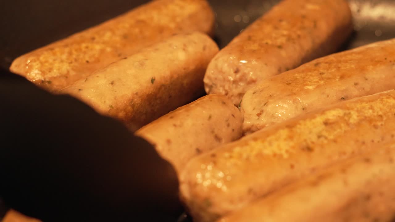 Chef with Tongs Turning Fake Meat Sausages in Hot Pan - Slow Motion Footage