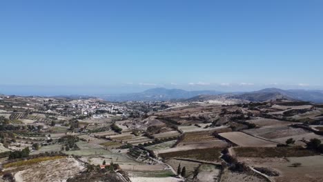 A-Cretan-village-panoramic-shot-would-typically-depict-a-wide,-expansive-view-of-a-traditional-Cretan-village