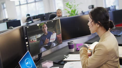 mujer de negocios asiática en la oficina usando computadora con videollamadas y mensajería ai en pantallas