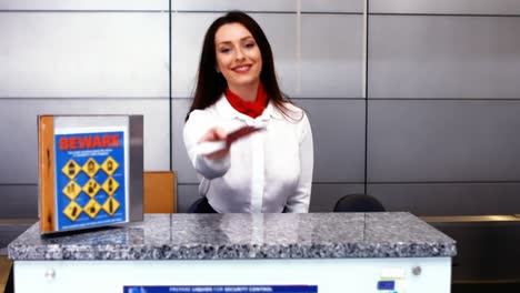 personal femenino del aeropuerto comprobando el pasaporte en el mostrador de facturación