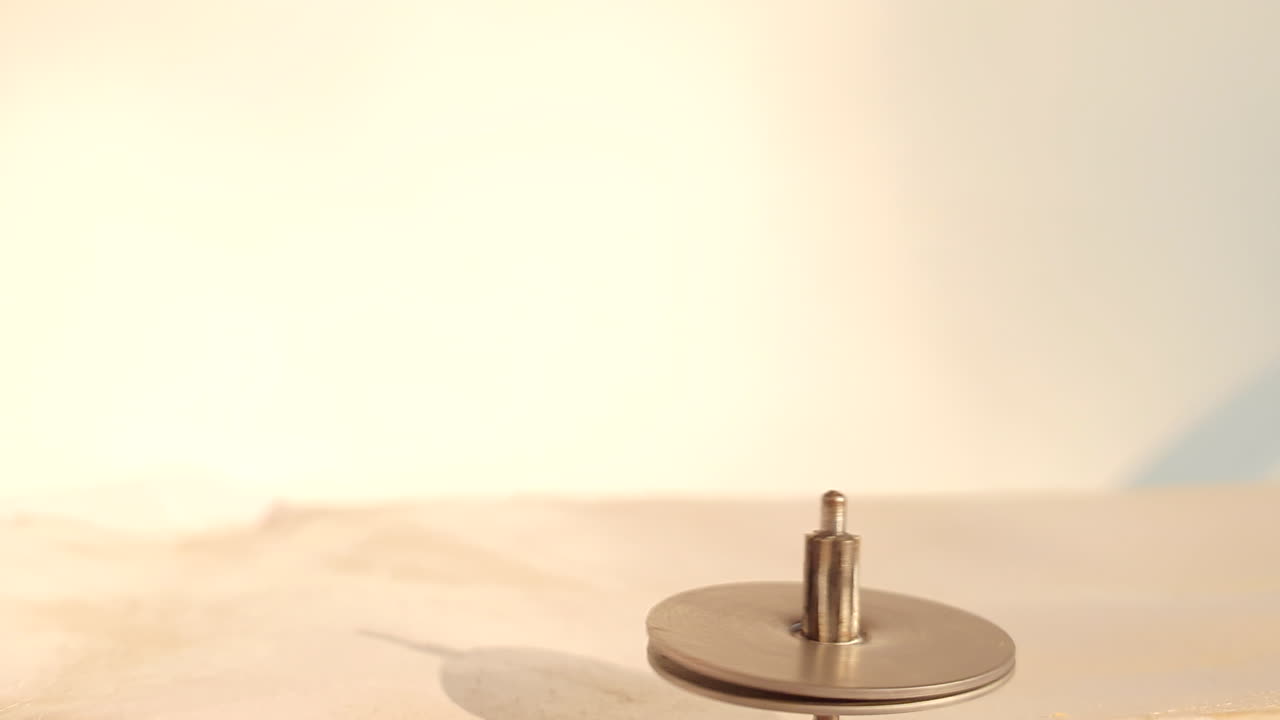 Spinning toy iron a rounding string also called lattoo in india. Its a kids game rounding fast.