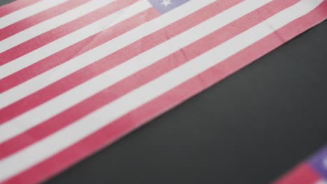 Video-of-three-flags-of-united-states-of-america-on-grey-background