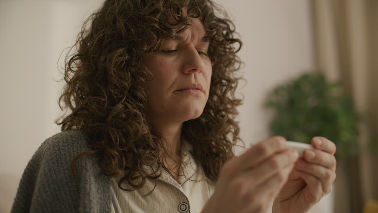 Sick Woman Coughing and Checking Temperature with Thermometer