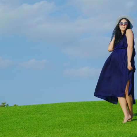 Happy-Pregnant-Woman-Is-Walking-In-The-Park-Smiling-1