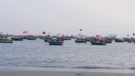 dolly shot along da nang beach with hundreds of boats docked in the ocean