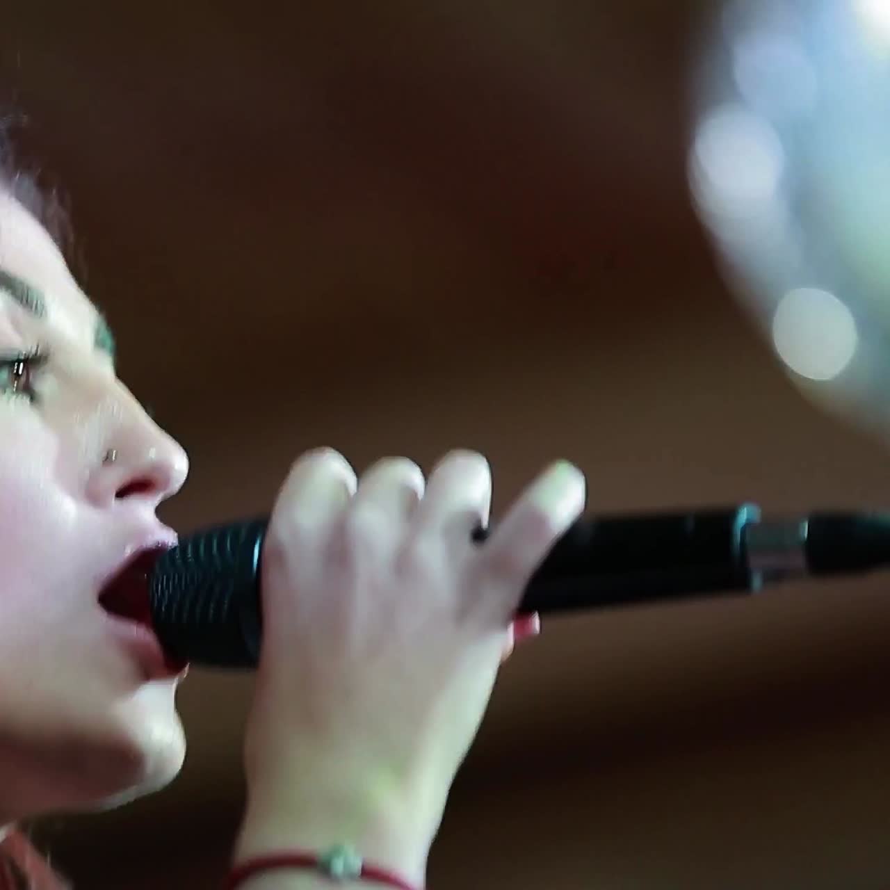 Singing under spotlight