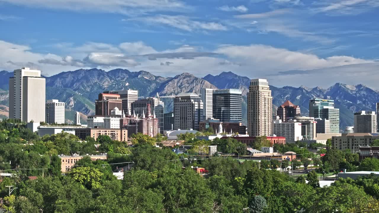 Salt Lake City Downtown Buildings and Wasatch Mountains Aerial Crane shot