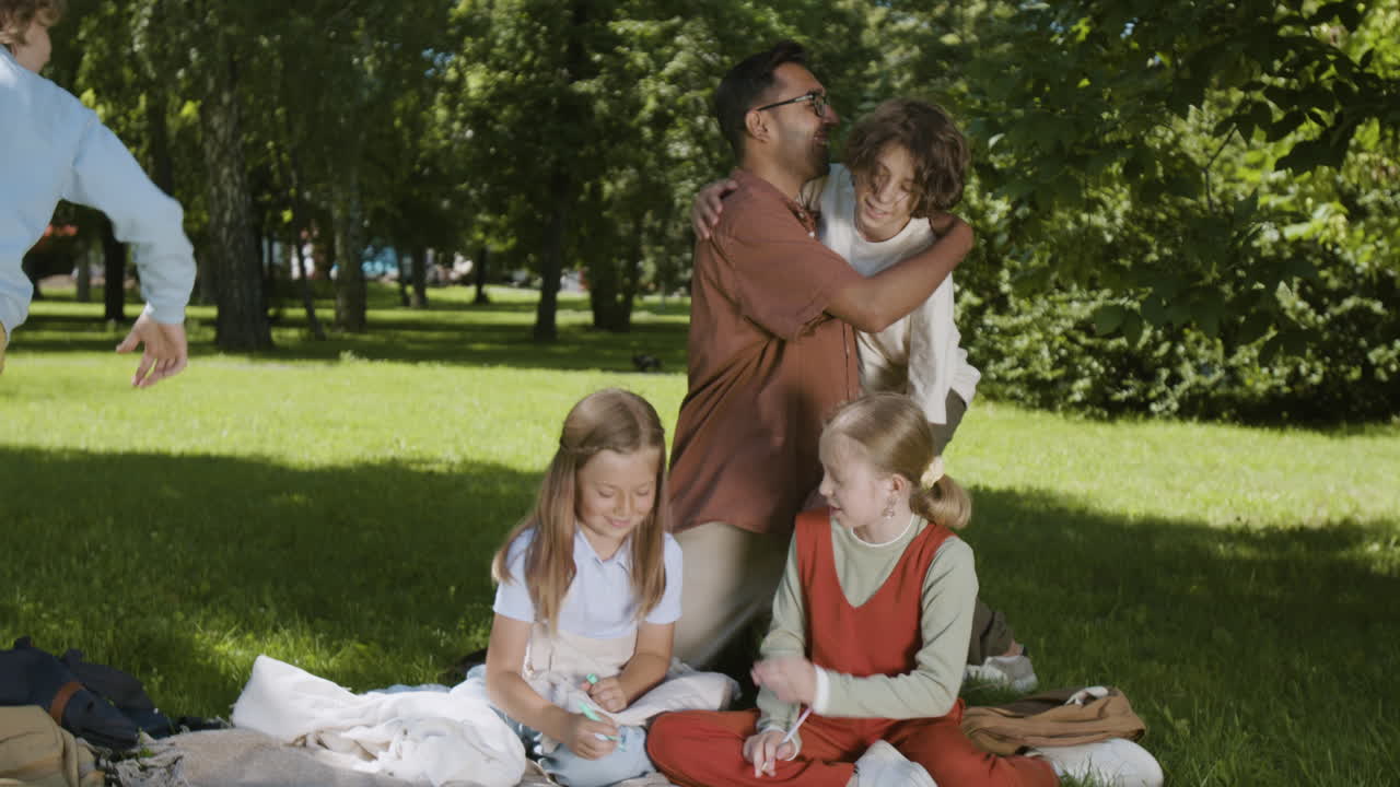 Children and Adult Enjoying Outdoor Activities in a Sunny Park