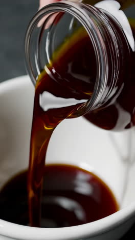 pouring dark liquid into a bowl