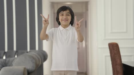 Happy-Indian-boy-showing-victory-sign