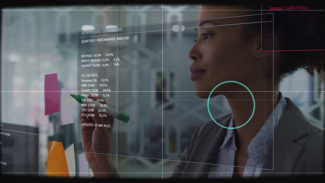 Woman studying HUD highlight appearing, marking glass and tapping notes with marker for business