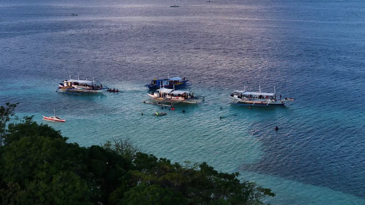 Tourists on Boats in a Tropical Bay