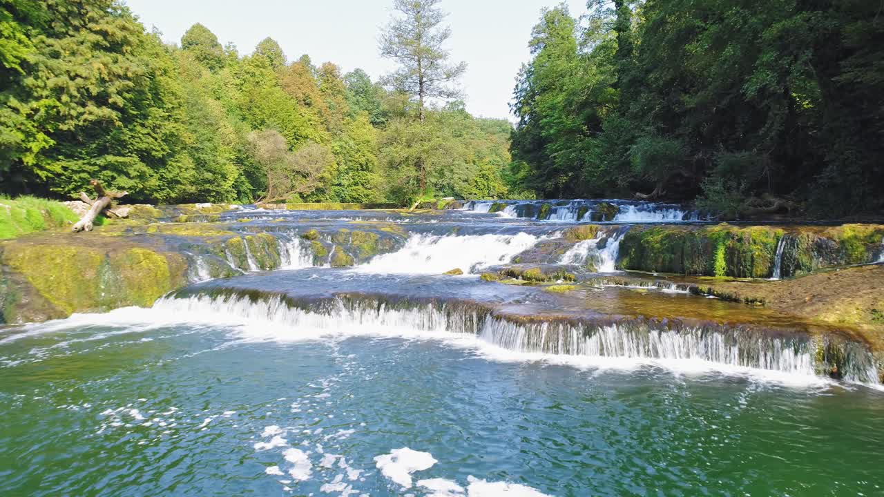 scenic fly over Krka river towards idyllic waterfall in Zuzemberg