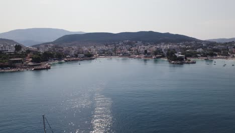 aerial flying towards ksamil riviera in albania over ionian sea waters establishing shot