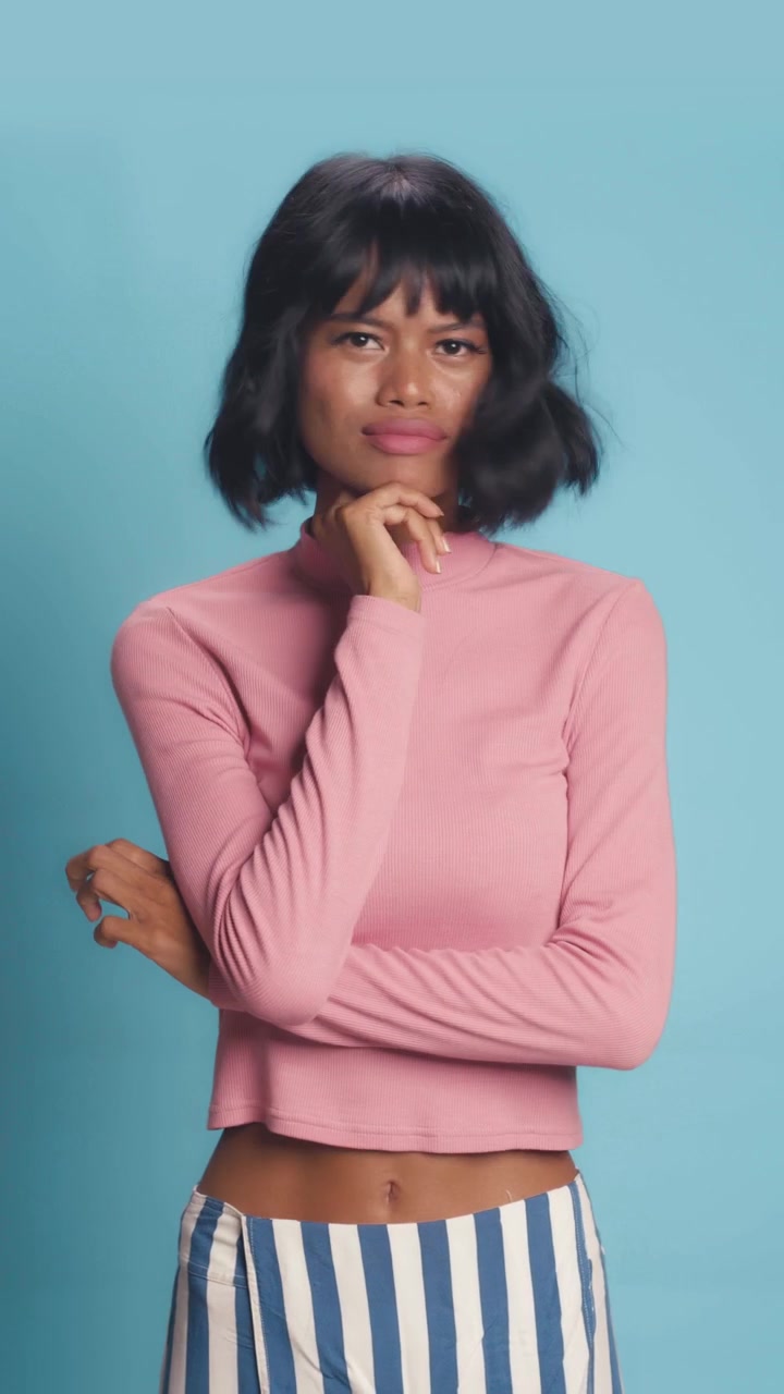 Uncertain southeast asian woman shrugging shoulders with confused expression