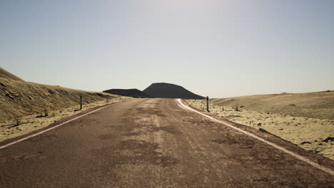 empty road leading through desert landscape