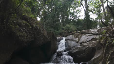 Ear-of-the-World-Waterfall-flows-through-dense-jungle-rocks-in-Minca,-Colombia