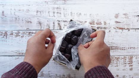 hands opening a box of dates