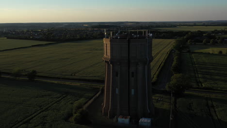 Aerial-footage-of-a-water-tower-on-a-summers-evening