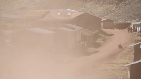 Truck-drives-fast-through-village