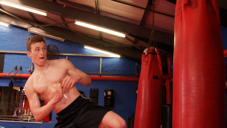 boxer practicing boxing with punching bag